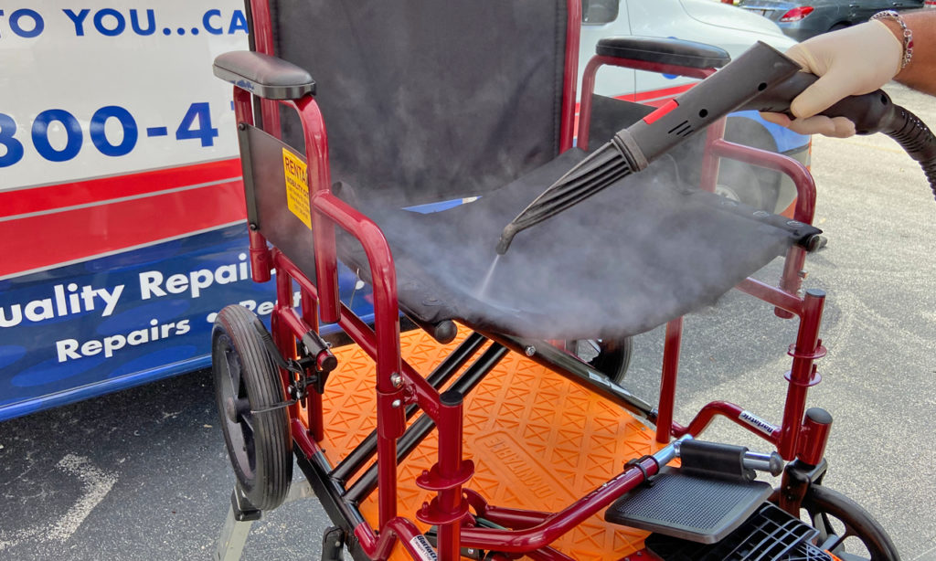 A wheelchair is cleaned and sanitized with steam.