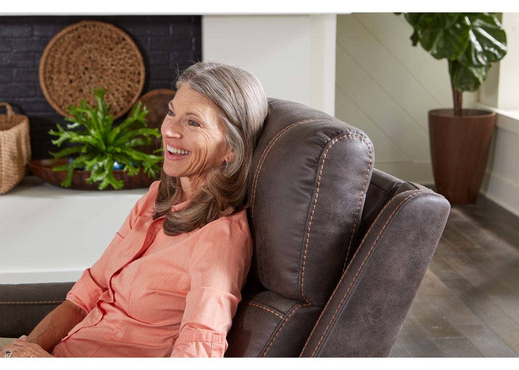 A woman relaxing in her lift chair recliner rental.