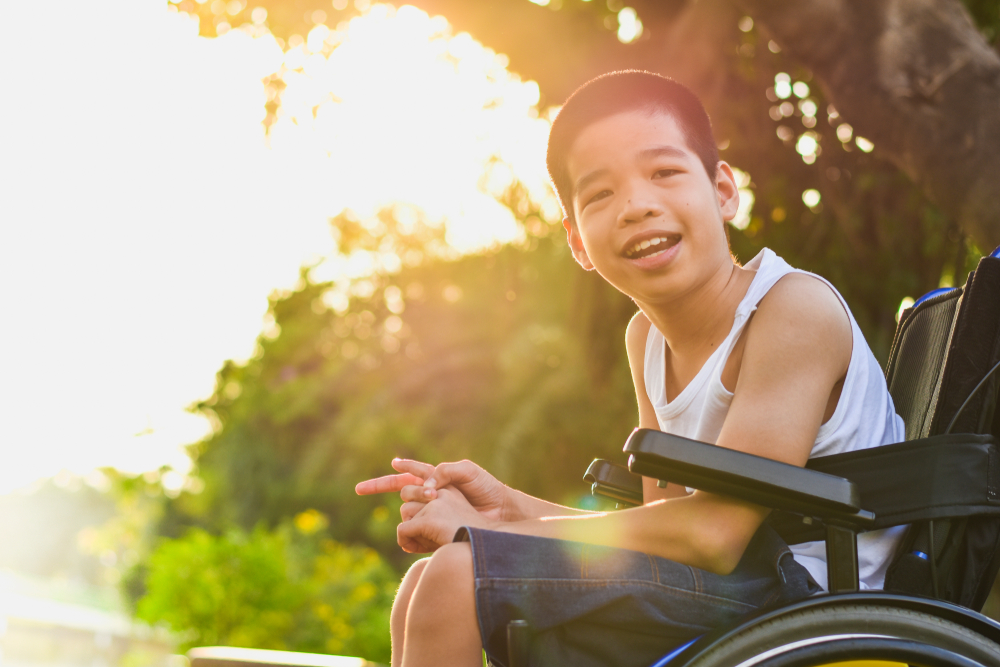 A young boy sitting in a wheelchair