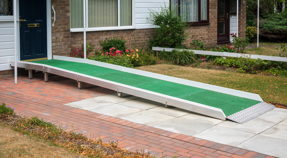 An aluminum mobility ramp with appropriate rise and a non-slip surface.