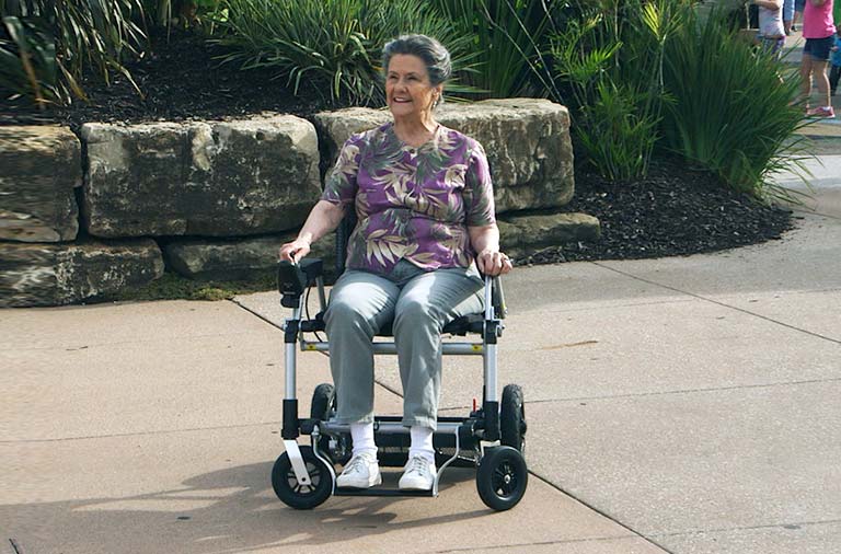 Woman using Zoomer Powerchair by Journey